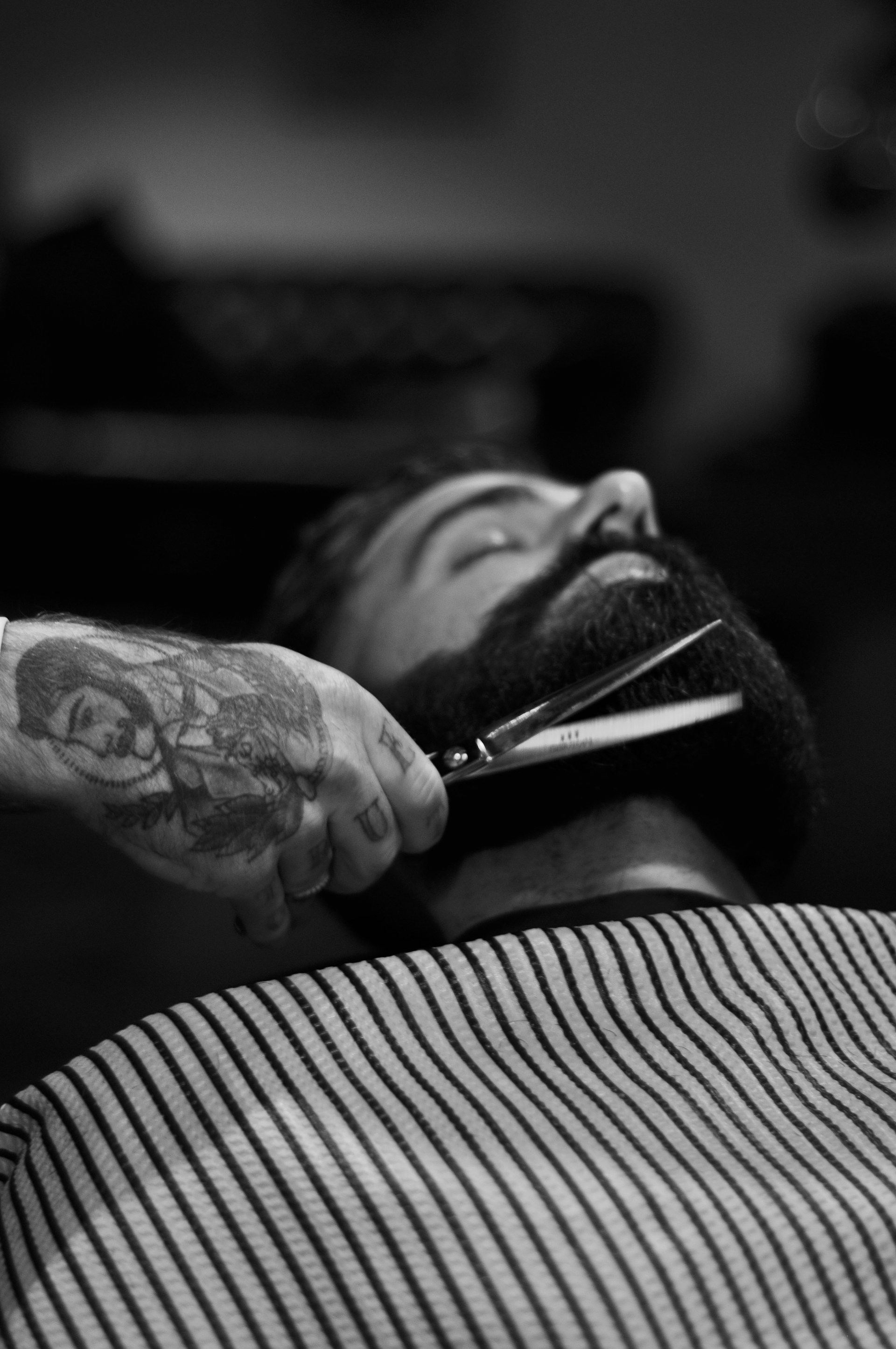 Expert beard trimming with professional scissors
